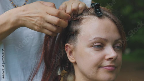 Process of weaving making boxer braids cornrows by a hair braider. photo