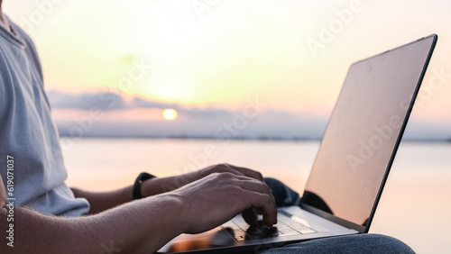 Crop man working on laptop