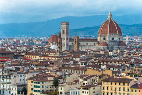 panoramic view of Firenze (Florence) at sunset, taken from Piazzale Michelangelo. historical landmarks, including the iconic Duomo and Palazzo Vechio, can be seen at a distance