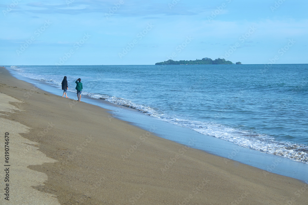 Photo of two girl walking on the beach