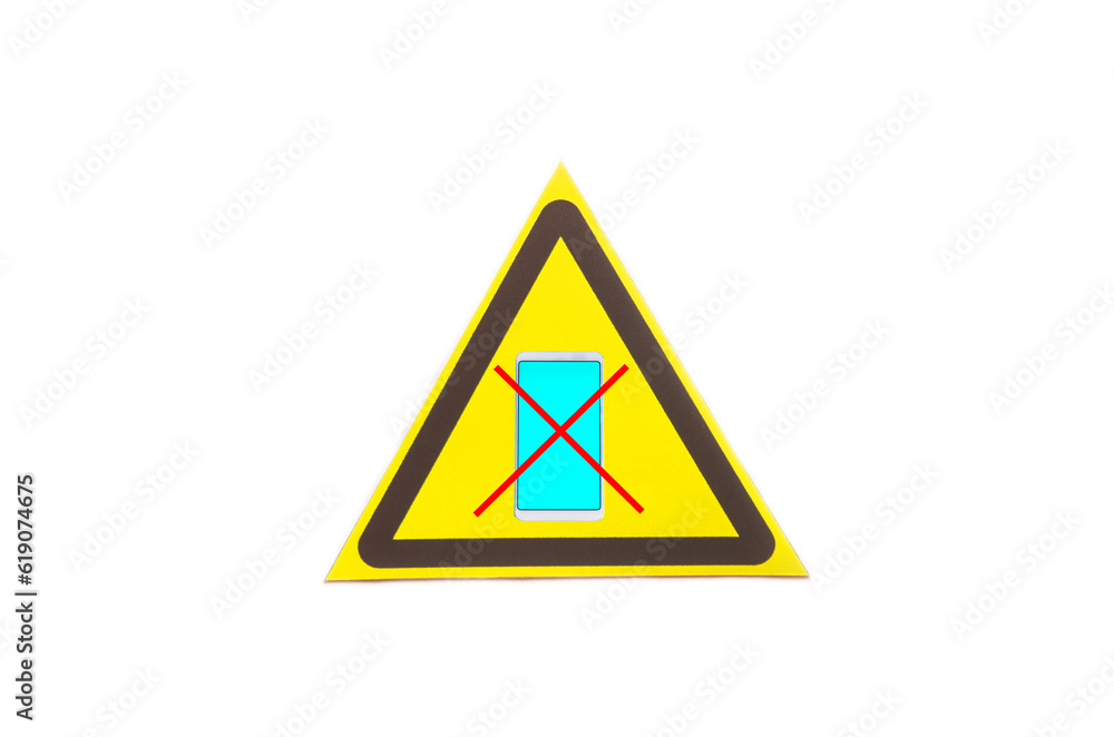 Warning sign crossed out smartphone in a yellow triangle on a light background close-up Warning sign crossed out smartphone in a yellow triangle on a light background close-up