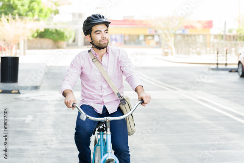 Businessman enjoying his commute to work riding a bicycle