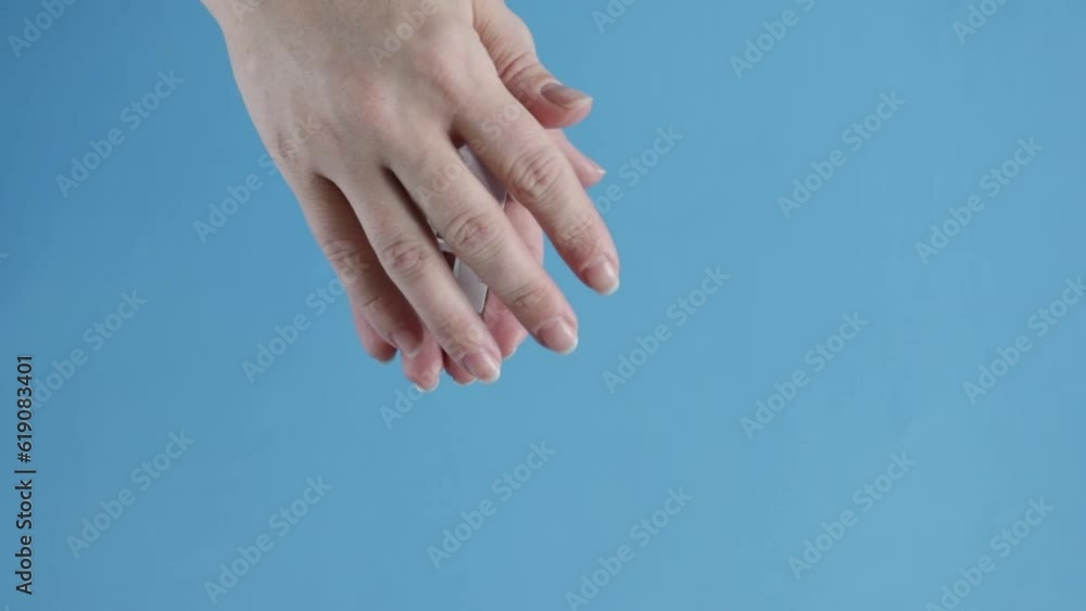 property insurance, real estate security, home protection, house is covered by female hands, blue background property insurance, real estate security, home protection, house is covered by female hands, blue background