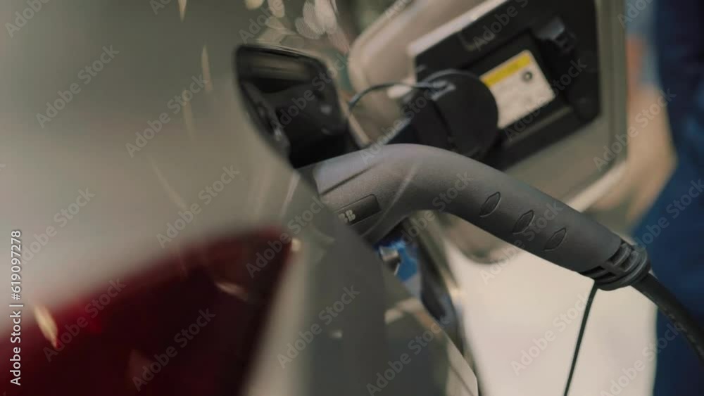 close-up Charging modern electric car on the street, concept future of the Automobile green energy ecology close-up Charging modern electric car on the street, concept future of the Automobile green energy ecology