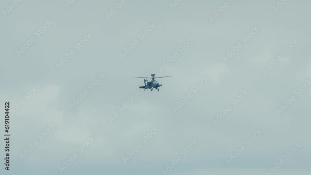close-up of British army Boeing Apache Attack helicopter gunship AH64E AH-64E performing pilot military flight training manoeuvres, Wiltshire UK close-up of British army Boeing Apache Attack helicopter gunship AH64E AH-64E performing pilot military flight training manoeuvres, Wiltshire UK