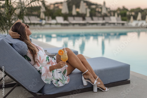 woman enjoying a glass of cocktail on a luxury resort
