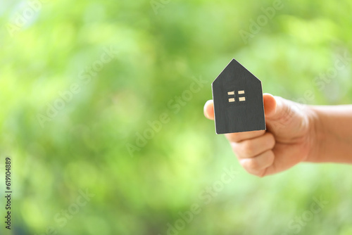 Successful Home Loan Investment with Hand Holding Coins on Nature Background - Wealth and Growth Concept. Financial Success in Real Estate Hand Representing Home Loan and Investment.