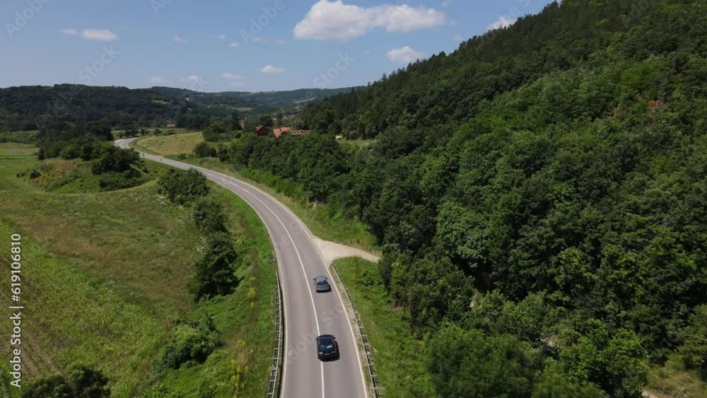 Aerial drone View of Cars Driving on Sunny summer Day on the road Aerial drone View of Cars Driving on Sunny summer Day on the road