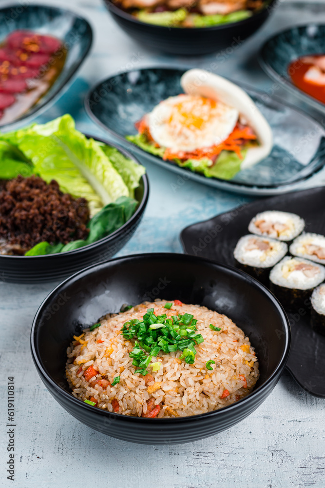 Rice with chicken, soup with noodle and minced pork and flatbread with bacon and fried egg on a table. Rice with chicken, soup with noodle and minced pork and flatbread with bacon and fried egg on a table.