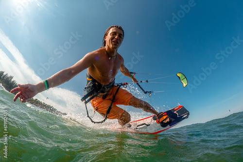 Canvas Print A kite surfer rides the waves