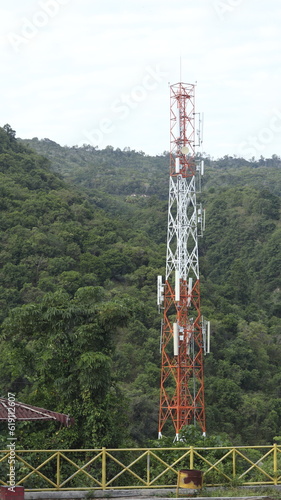 Communication Building Antenna with a backdrop of mountains and sky