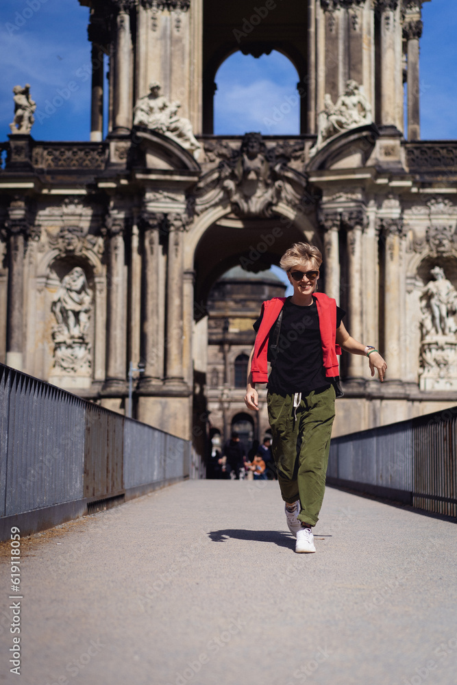 Woman in front of the Crown Gate of the Zwinger Palace, Dresden.