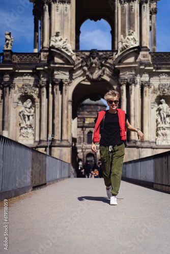 Woman in front of the Crown Gate of the Zwinger Palace, Dresden.