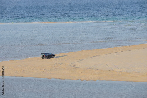 Fototapeta Naklejka Na Ścianę i Meble -  Enthusiasts in Qatar drive to sand dunes in their SUV during weekends.  Dune bashing is a great leisure time sport in Qatar. 