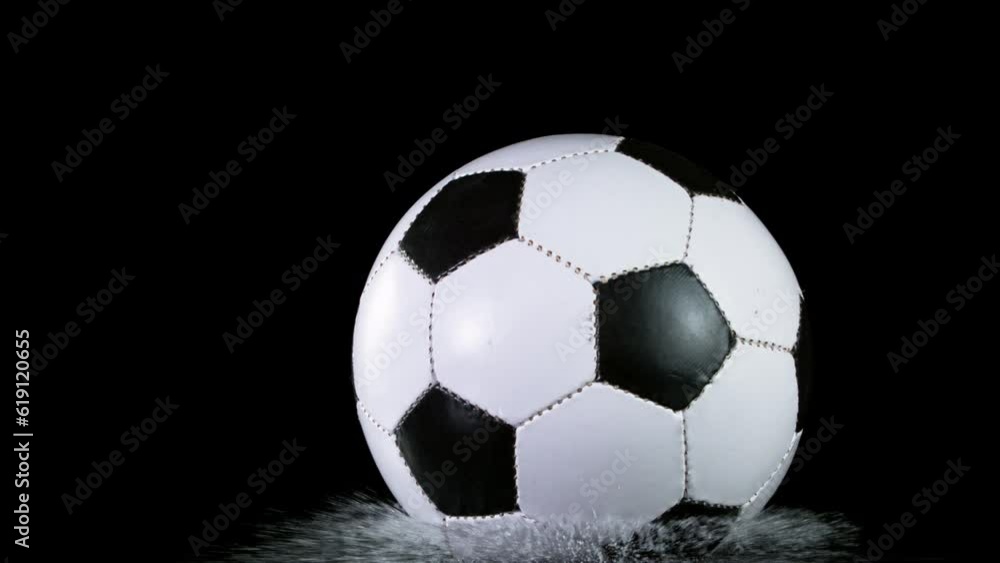 Close-up of Falling Soccer Ball on Water Black Surface. Super Slow Motion at 1000 fps. Filmed on High Speed Cinematic Camera. Close-up of Falling Soccer Ball on Water Black Surface. Super Slow Motion at 1000 fps. Filmed on High Speed Cinematic Camera.