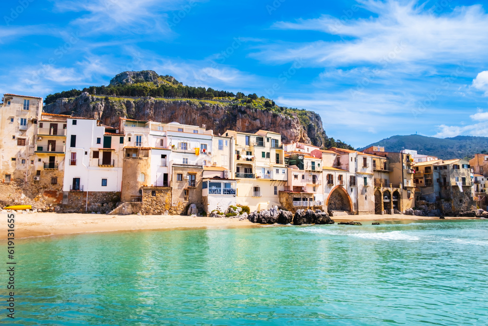 Fototapeta premium Cefalu, medieval town on Sicily island, Italy. Seashore village with beach and clear turquoise water of Tyrrhenian sea, surrounded with mountains. Popular tourist attraction in Province of Palermo