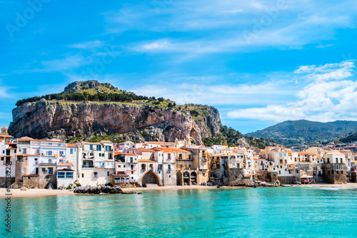 Fototapeta Naklejka Na Ścianę i Meble -  Cefalu, medieval town on Sicily island, Italy. Seashore village with beach and clear turquoise water of Tyrrhenian sea, surrounded with mountains. Popular tourist attraction in Province of Palermo