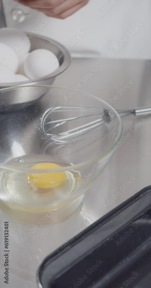 Hands manually beating eggs for food preparation. Hands manually beating eggs for food preparation.