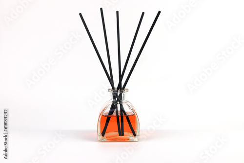 luxury aroma scent reed diffuser glass bottle is on the white table to creat romantic and relax ambient in the bedroom with white cement wall background on the happy valentine day (clipping path )