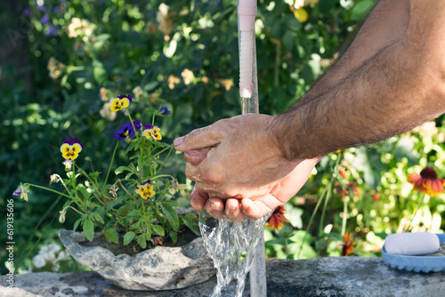 Washing hands. Man washing his hands in the garden. Hygiene and Cleaning Hands. 