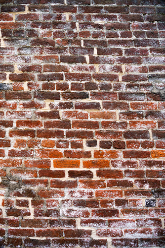 brick wall, background of old red bricks with lime residue.