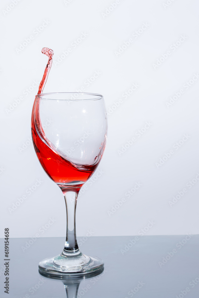 A beautiful splash of red wine in a glass