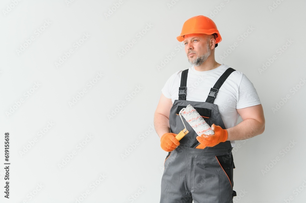 Man stand in the room with paint roller in his hand Man stand in the room with paint roller in his hand
