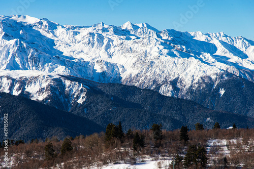 Beautiful nature lanscape with Caucasus mountain and pine forest covered with snow in winter. Cable car at Hatsvali ski resort Mestia Georgia