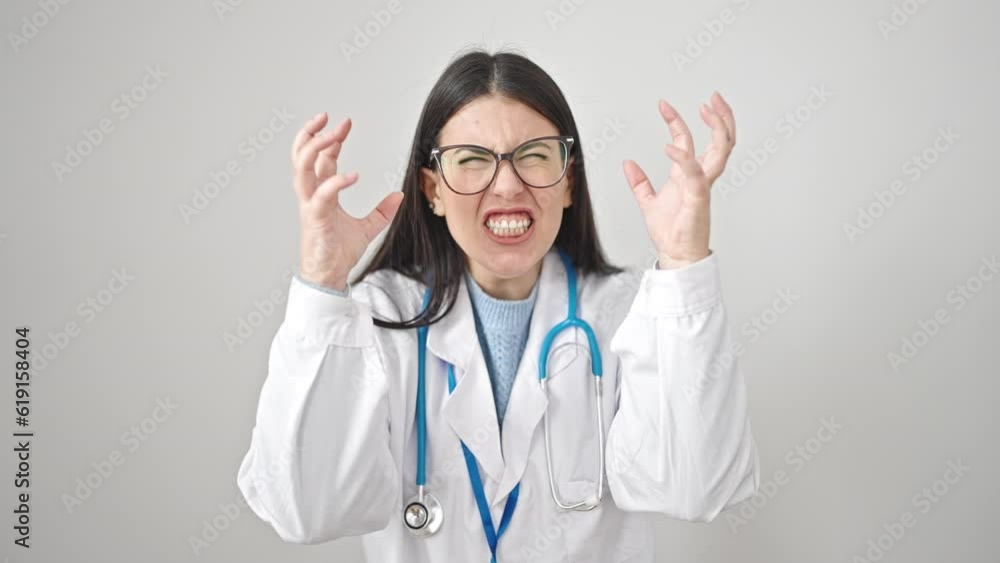 Young hispanic woman doctor angry and stressed over isolated white background Young hispanic woman doctor angry and stressed over isolated white background
