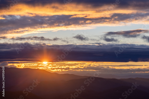 Winter Sunset through lines of clouds over Blue Ridge Mountains