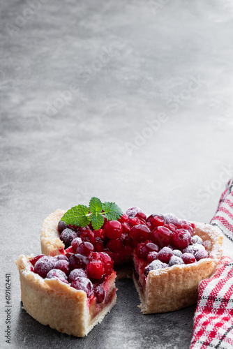 Tasty homemade cranberry pie on gray background