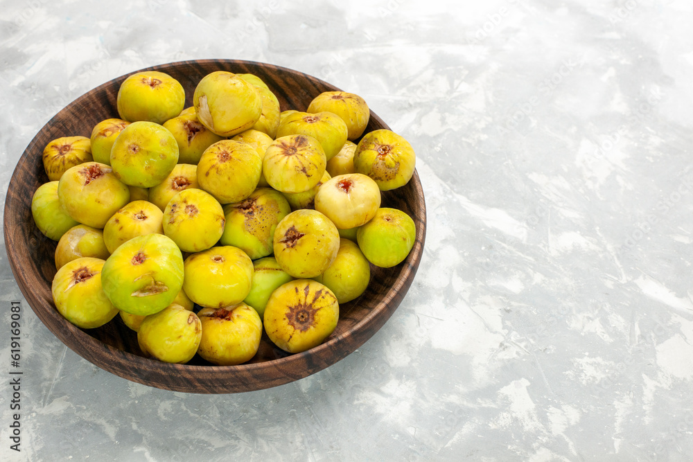 front view fresh sweet figs inside brown plate on light desk tree plant fruit fresh mellow taste front view fresh sweet figs inside brown plate on light desk tree plant fruit fresh mellow taste