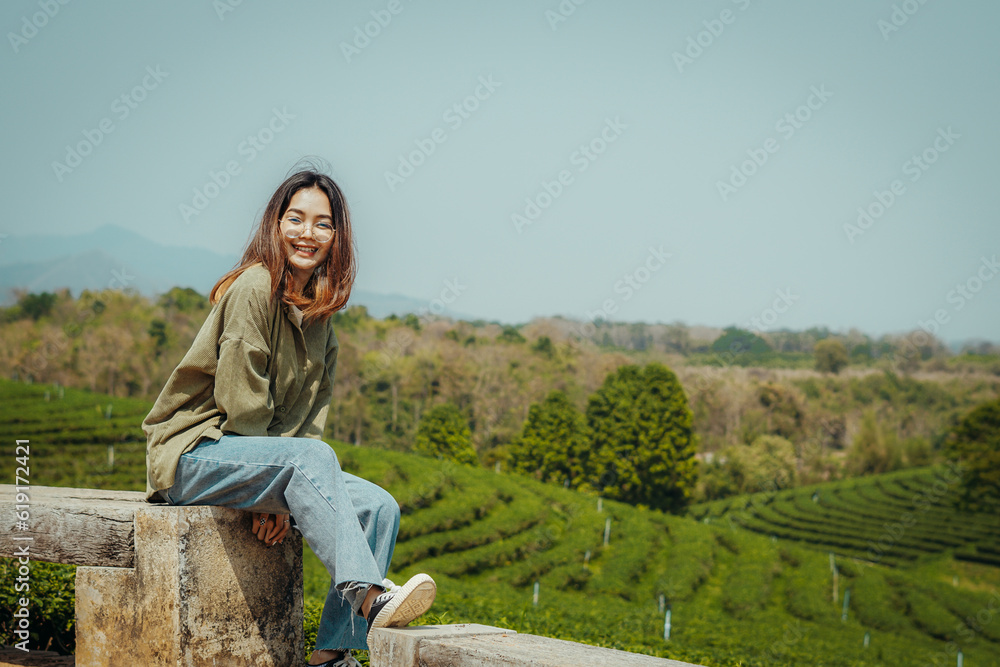 woman in a green tea farm field, in traveling concept.