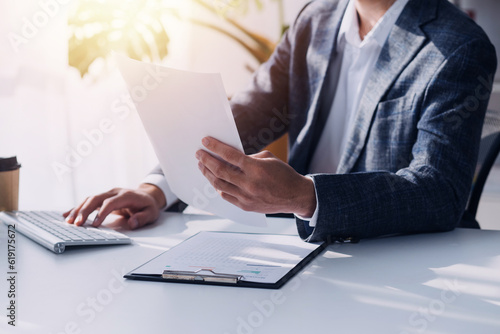 Schilderij op canvas Financial analysts analyze business financial reports on a digital tablet planning investment project during a discussion at a meeting of corporate showing the results of their successful teamwork