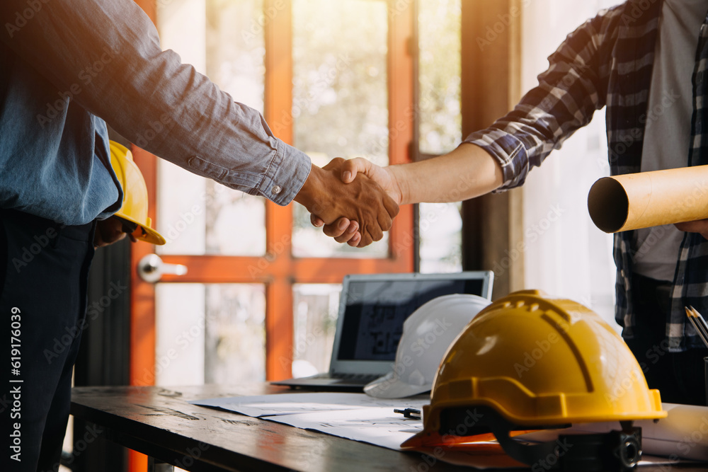 Construction and structure concept of Engineer or architect meeting for project working with partner and engineering tools on model building and blueprint in working site, contract for both companies. Construction and structure concept of Engineer or architect meeting for project working with partner and engineering tools on model building and blueprint in working site, contract for both companies.
