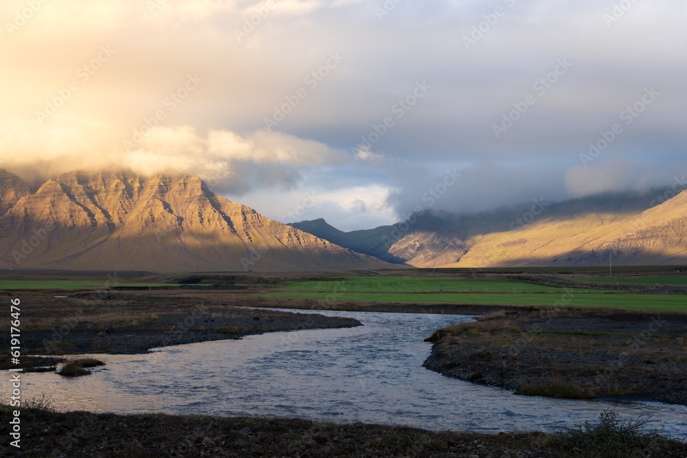 Scenic view of countryside at Snaefellsnes peninsula, Iceland. River and mountains at sunset