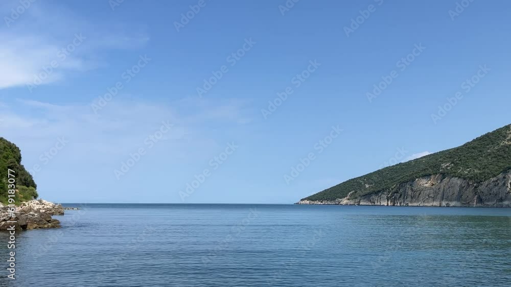 Sea calm blue water with rocks, Valdanos beach in Montenegro Sea calm blue water with rocks, Valdanos beach in Montenegro