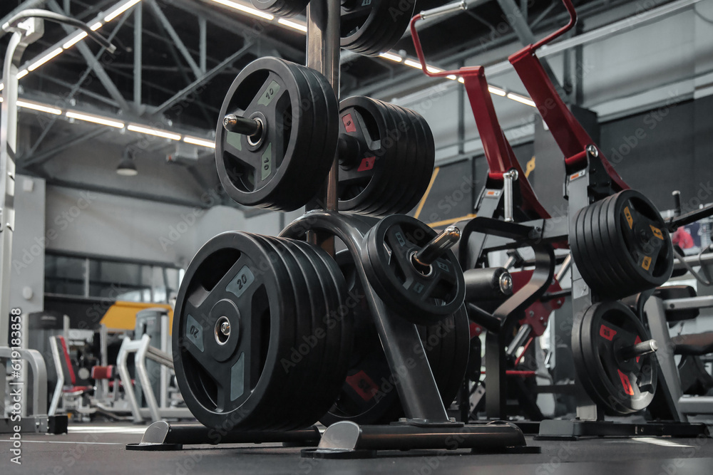 New gym interior with sports equipment sport weight barbell on rack ...