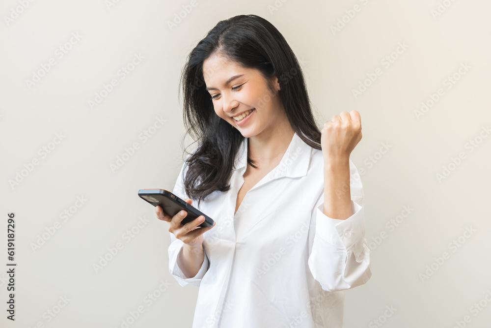 Happy asian young woman using mobile smart phone, read good news online feel excited getting offer, great positive surprise, celebrate success on smartphone. Businesswoman isolated on white background Happy asian young woman using mobile smart phone, read good news online feel excited getting offer, great positive surprise, celebrate success on smartphone. Businesswoman isolated on white background