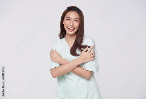 Happy asian woman patient hug yourself isolated on white studio background. life insurance and coverage concept.