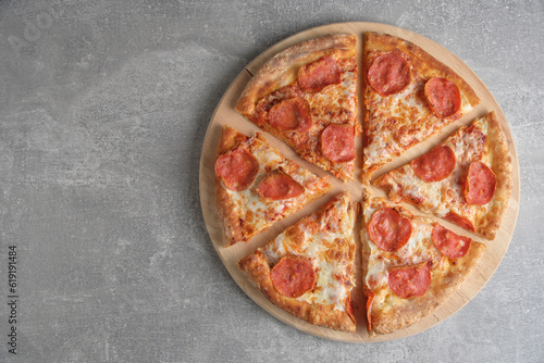 Pepperoni pizza with sausage gray concrete background.