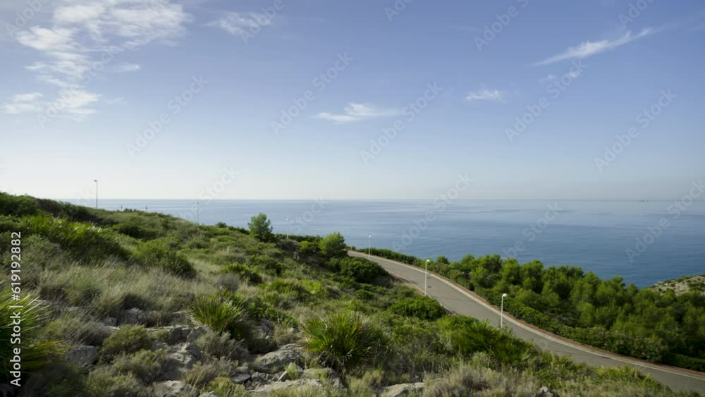 Asphalt road in the hills of Spain near the sea. Province of Castellon. Favorite place for active walks. VIA VERDE BENICASIM OROPESA. Oropesa del Mar Asphalt road in the hills of Spain near the sea. Province of Castellon. Favorite place for active walks. VIA VERDE BENICASIM OROPESA. Oropesa del Mar