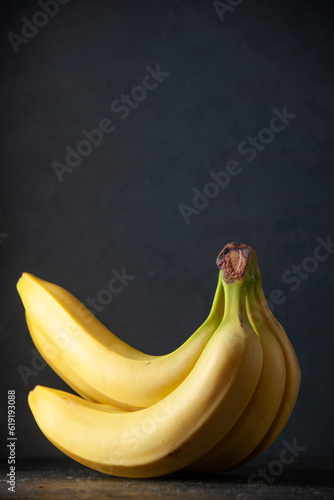 front view fresh yellow bananas on dark background exotic fruit ripe food darkness tropical taste photo