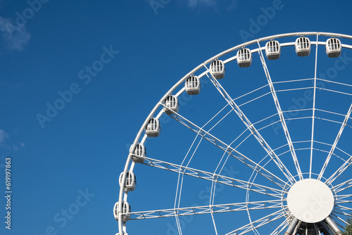 ferris wheel ride in amusement park on blue sky background. High quality photo