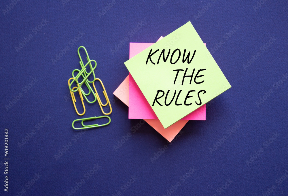 Know the rules symbol. Yellow steaky note with paper clips with words