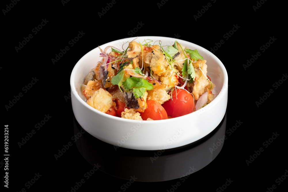 Japanese shrimps salad Ebi salad in bowl on a black background with reflection.