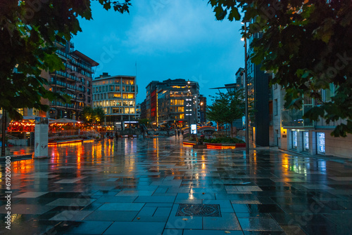 Illuminated Akker Brygge, a modern district in Oslo city center at night and in the rain, Norway