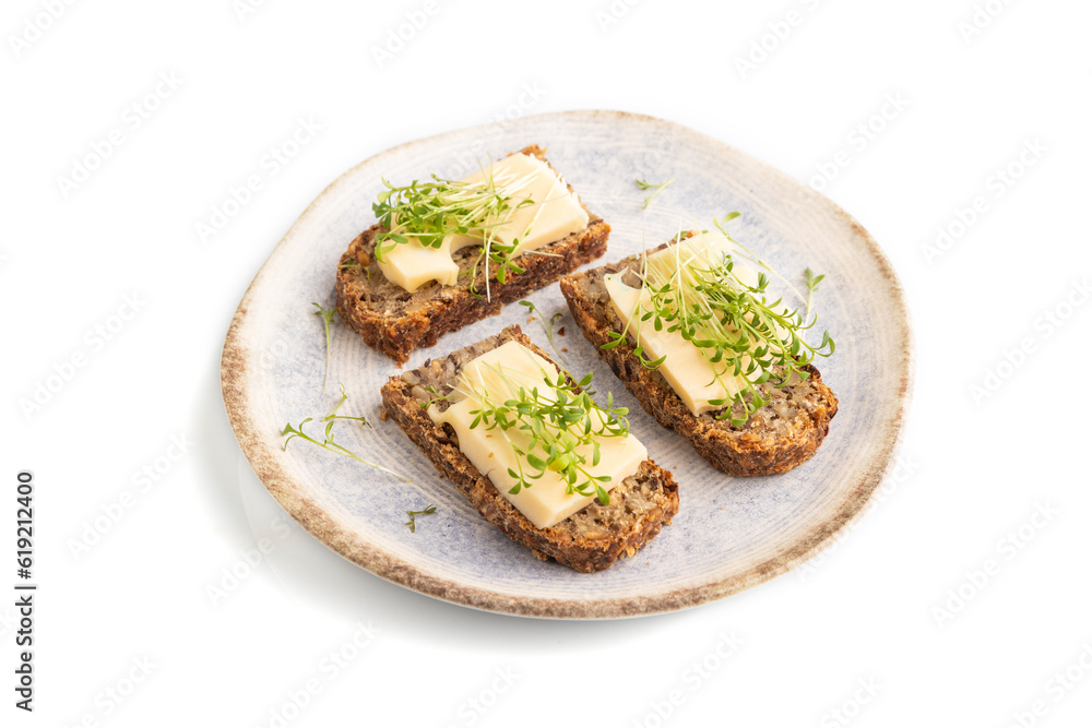 Grain bread sandwiches with cheese and watercress microgreen isolated on white, side view, close up.