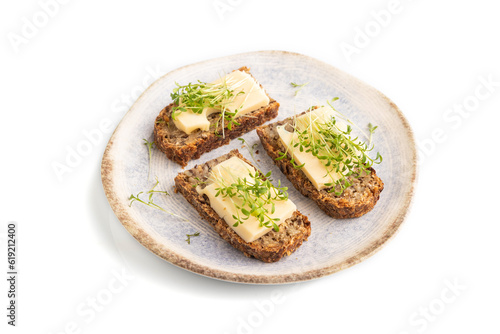 Grain bread sandwiches with cheese and watercress microgreen isolated on white, side view, close up.