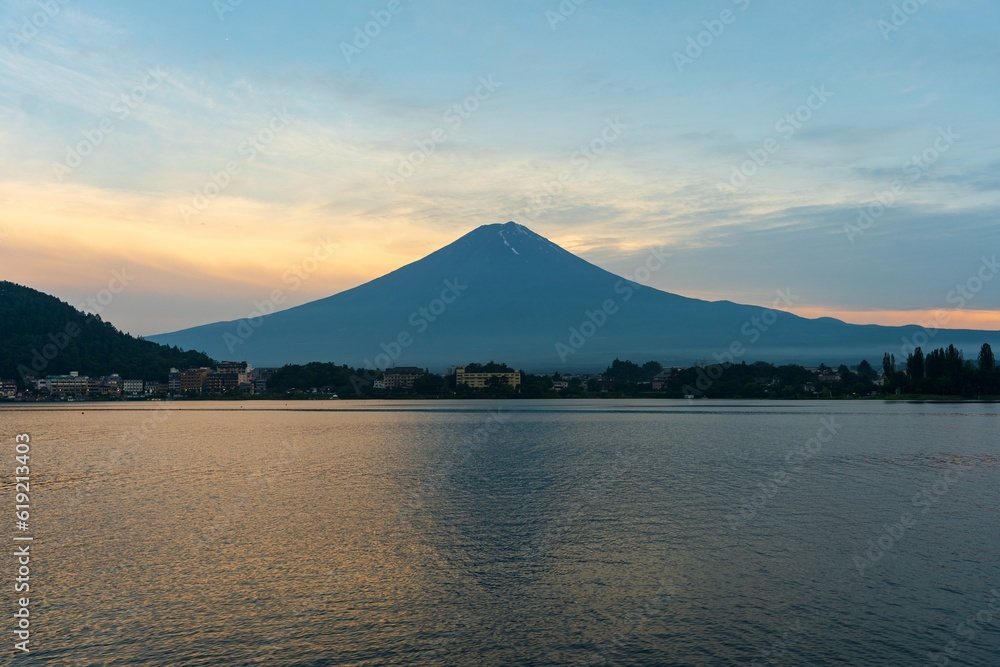 Mount Fuji looming over beautiful mountain lake at sunset in Japan